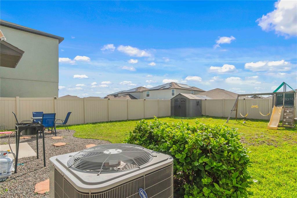 9440 Lemon Drop Loop Sun City Center, FL 33573 - Photo 52 of 55 a view of a backyard with sitting area