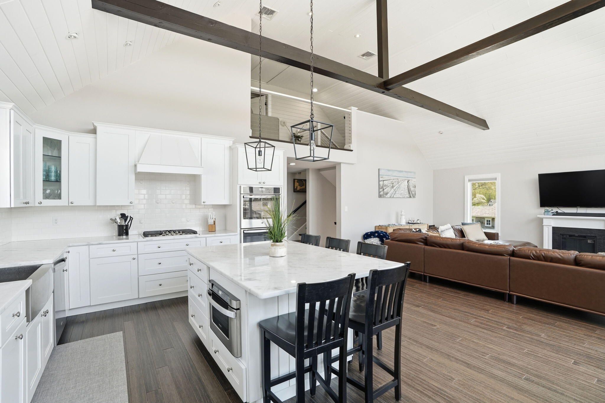 4 Cross Road Bourne, MA 02532 - Photo 14 of 47 a view of a kitchen island a chandelier and wooden floor