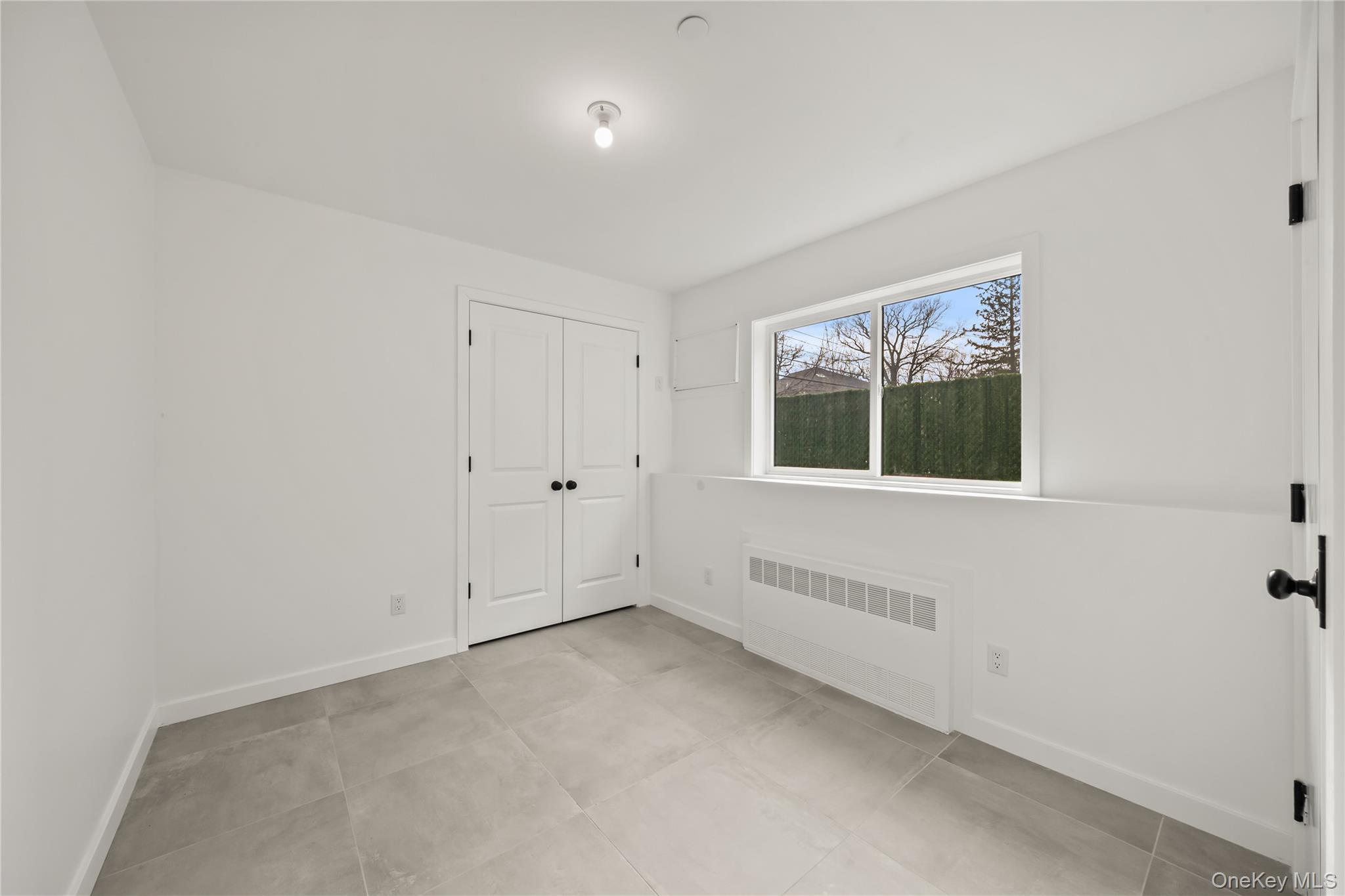 23 Singer Avenue, Unit 211 Spring Valley, NY 10977 - Photo 38 of 45 a view of an empty room with a window