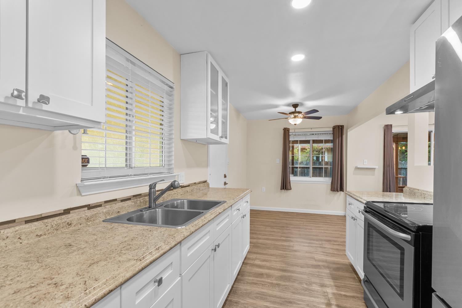 2121 Aaron Way Sacramento, CA 95822 - Photo 12 of 47 a large kitchen with a sink stove and cabinets