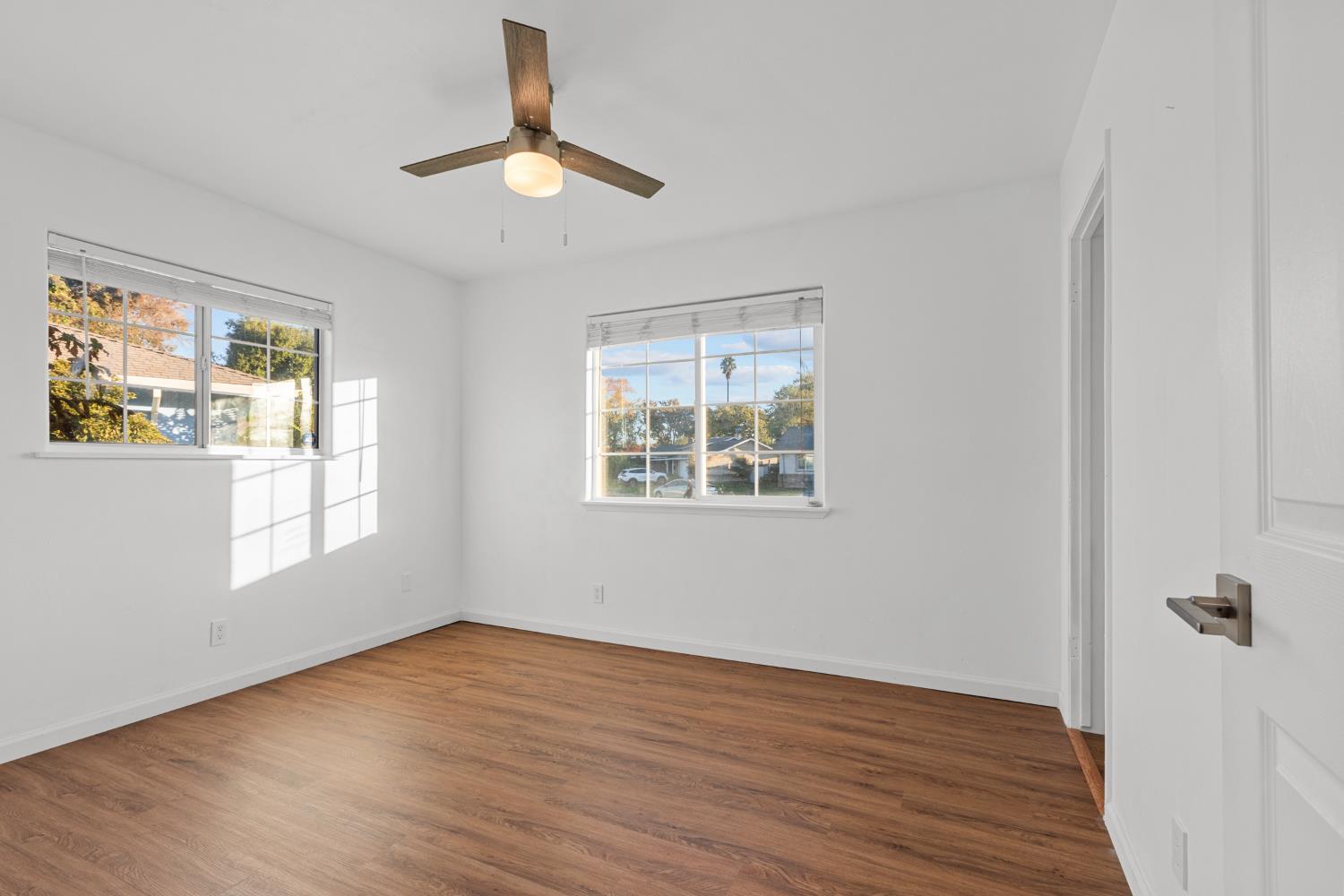 2121 Aaron Way Sacramento, CA 95822 - Photo 15 of 47 a view of an empty room with wooden floor and a window