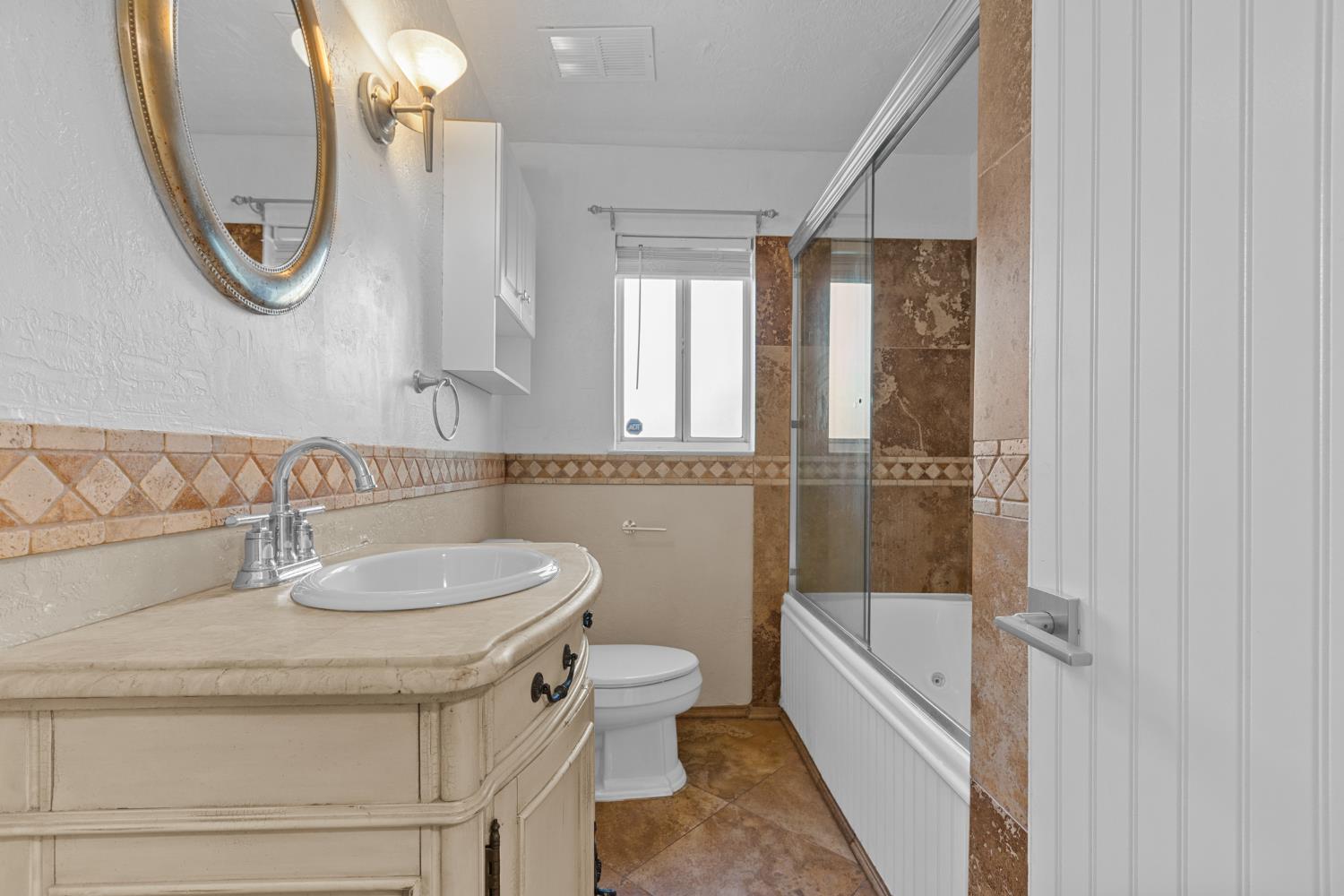 2121 Aaron Way Sacramento, CA 95822 - Photo 16 of 47 a bathroom with a sink a toilet and a mirror