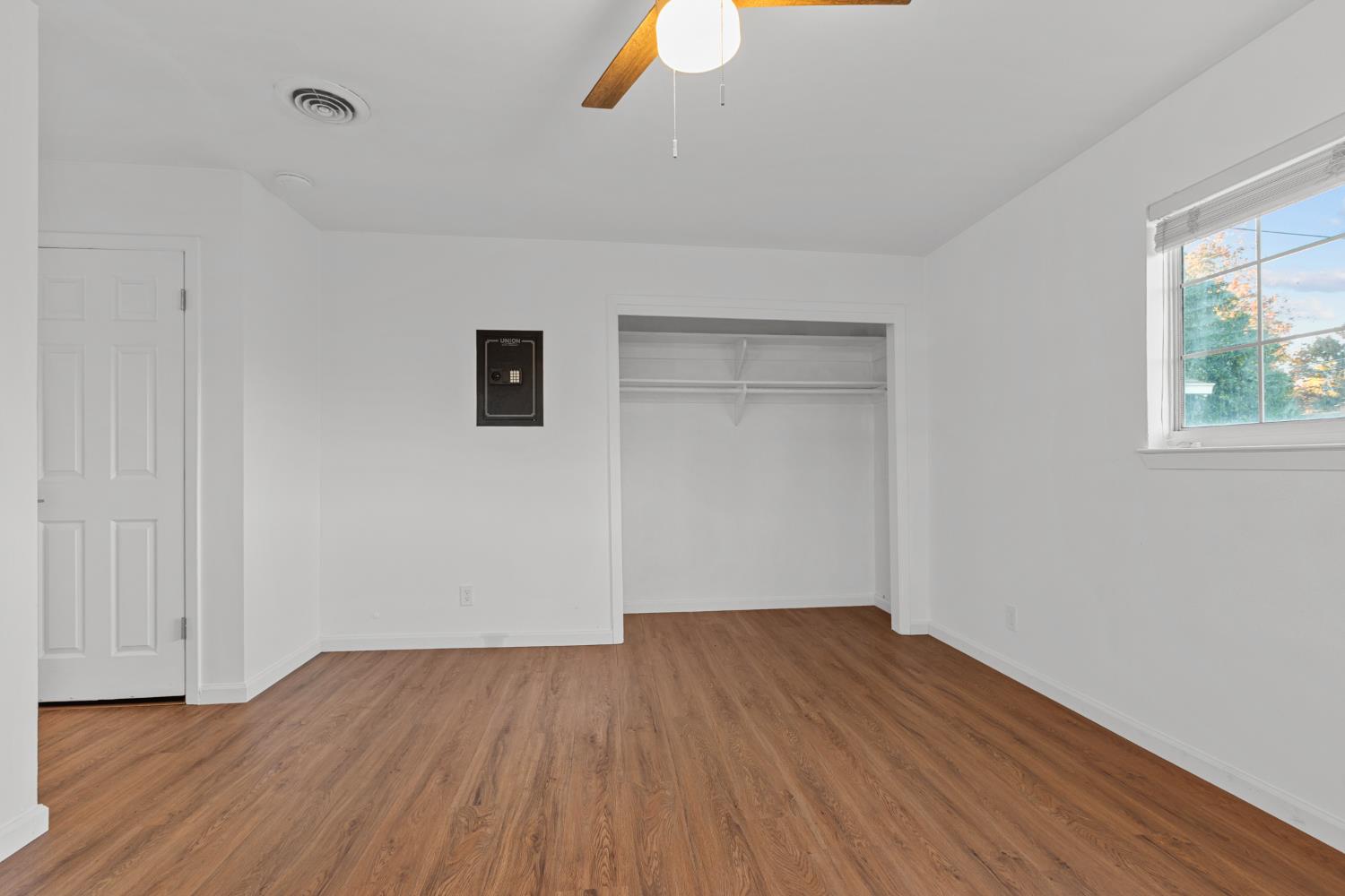 2121 Aaron Way Sacramento, CA 95822 - Photo 19 of 47 a view of an empty room with wooden floor and a window