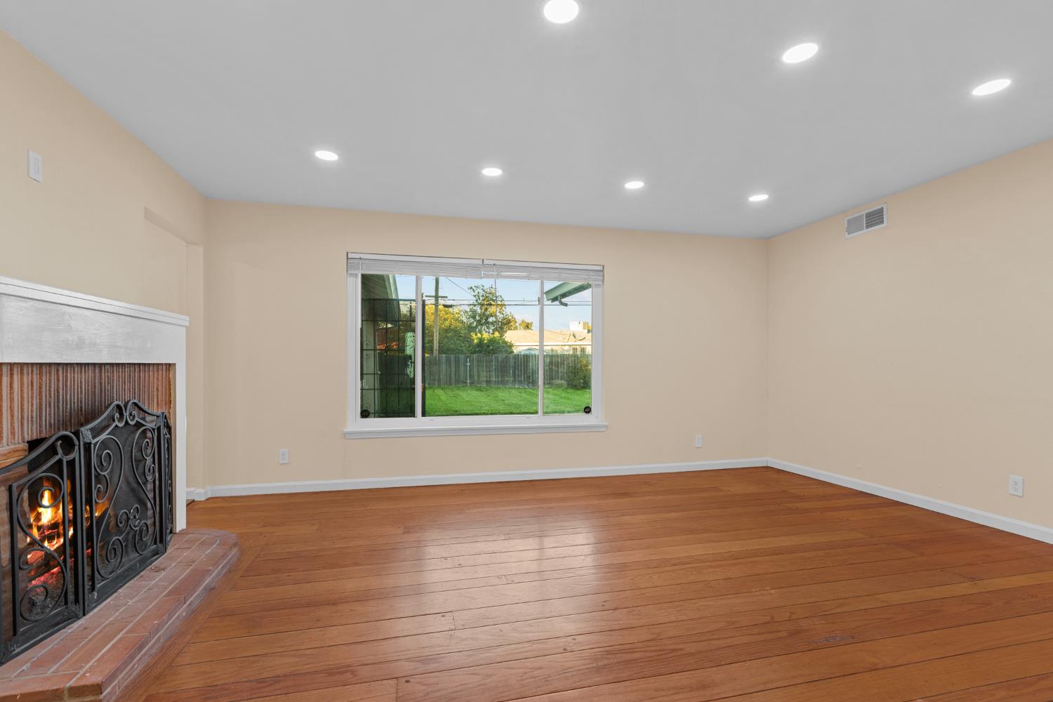 2121 Aaron Way Sacramento, CA 95822 - Photo 5 of 47 a view of an empty room with wooden floor and a window