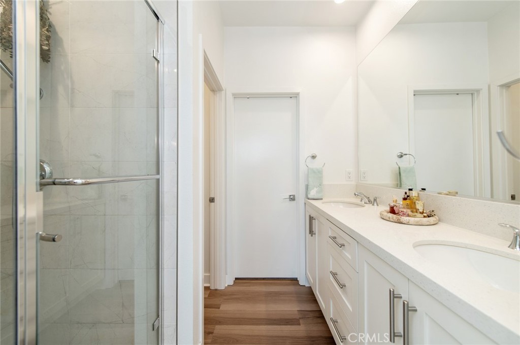 1515 West Bushell Street Anaheim, CA 92805 - Photo 11 of 22 a bathroom with a double vanity sink and a mirror