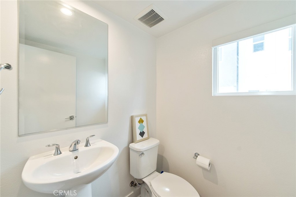 1515 West Bushell Street Anaheim, CA 92805 - Photo 15 of 22 a bathroom with a sink mirror and toilet