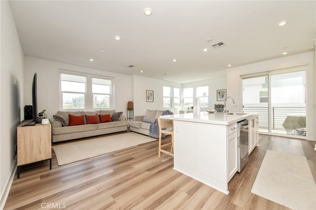 1515 West Bushell Street Anaheim, CA 92805 - Photo 2 of 22 a large white kitchen with a large window and stainless steel appliances