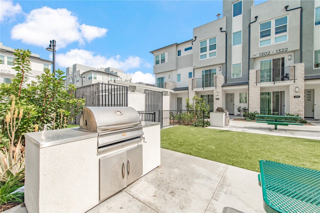 1515 West Bushell Street Anaheim, CA 92805 - Photo 21 of 22 a view of a white building with a yard in front of it