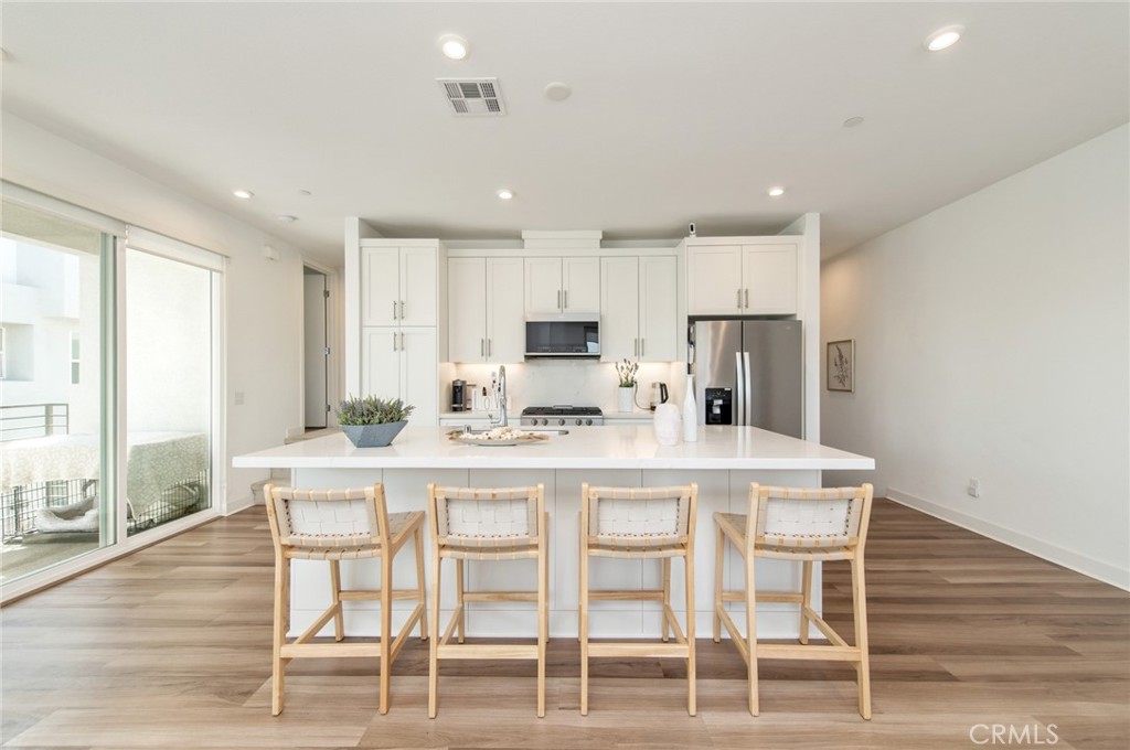 1515 West Bushell Street Anaheim, CA 92805 - Photo 5 of 22 a kitchen with kitchen island and white cabinets