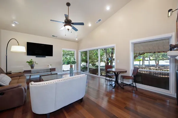 a living room with fireplace furniture and a large window