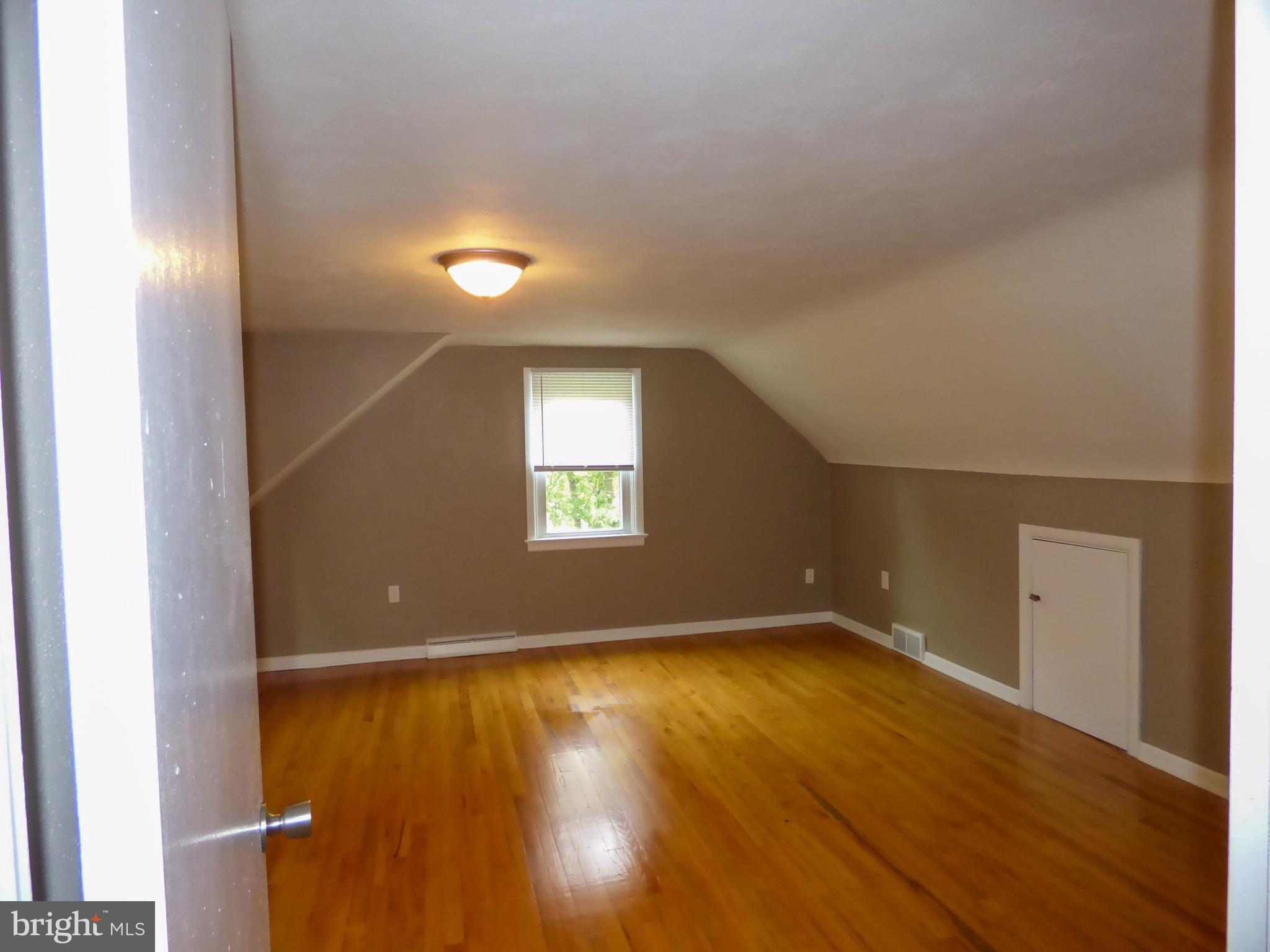 2390 Grandview Road York, PA 17403 - Photo 25 of 41 an empty room with wooden floor and windows