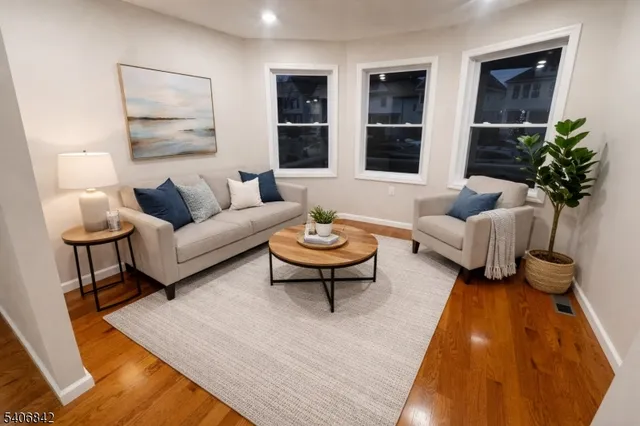 a living room with furniture a lamp a rug and a window