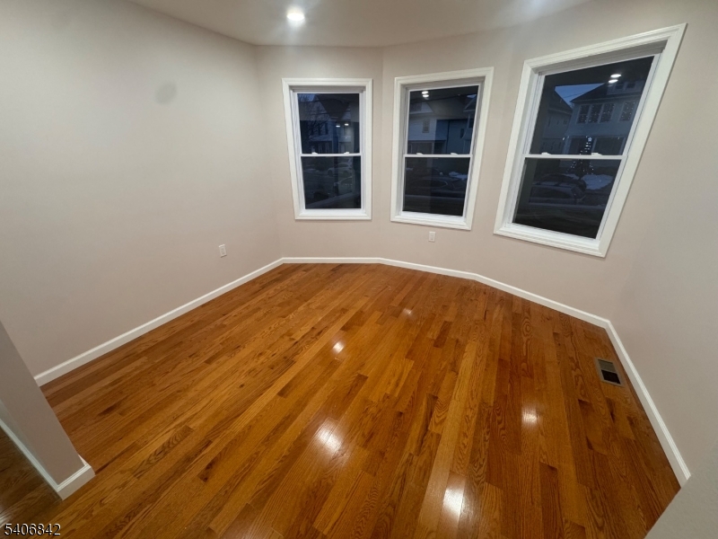 515 West End Avenue Elizabeth, NJ 07202 - Photo 3 of 9 a view of an empty room with wooden floor and windows