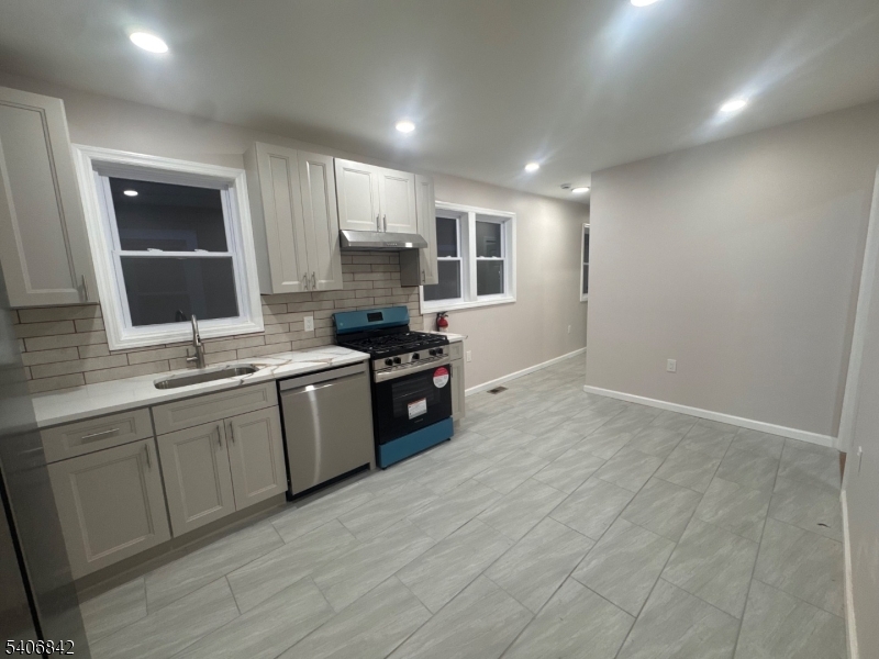 515 West End Avenue Elizabeth, NJ 07202 - Photo 6 of 9 a kitchen with stainless steel appliances granite countertop a stove a sink and a refrigerator