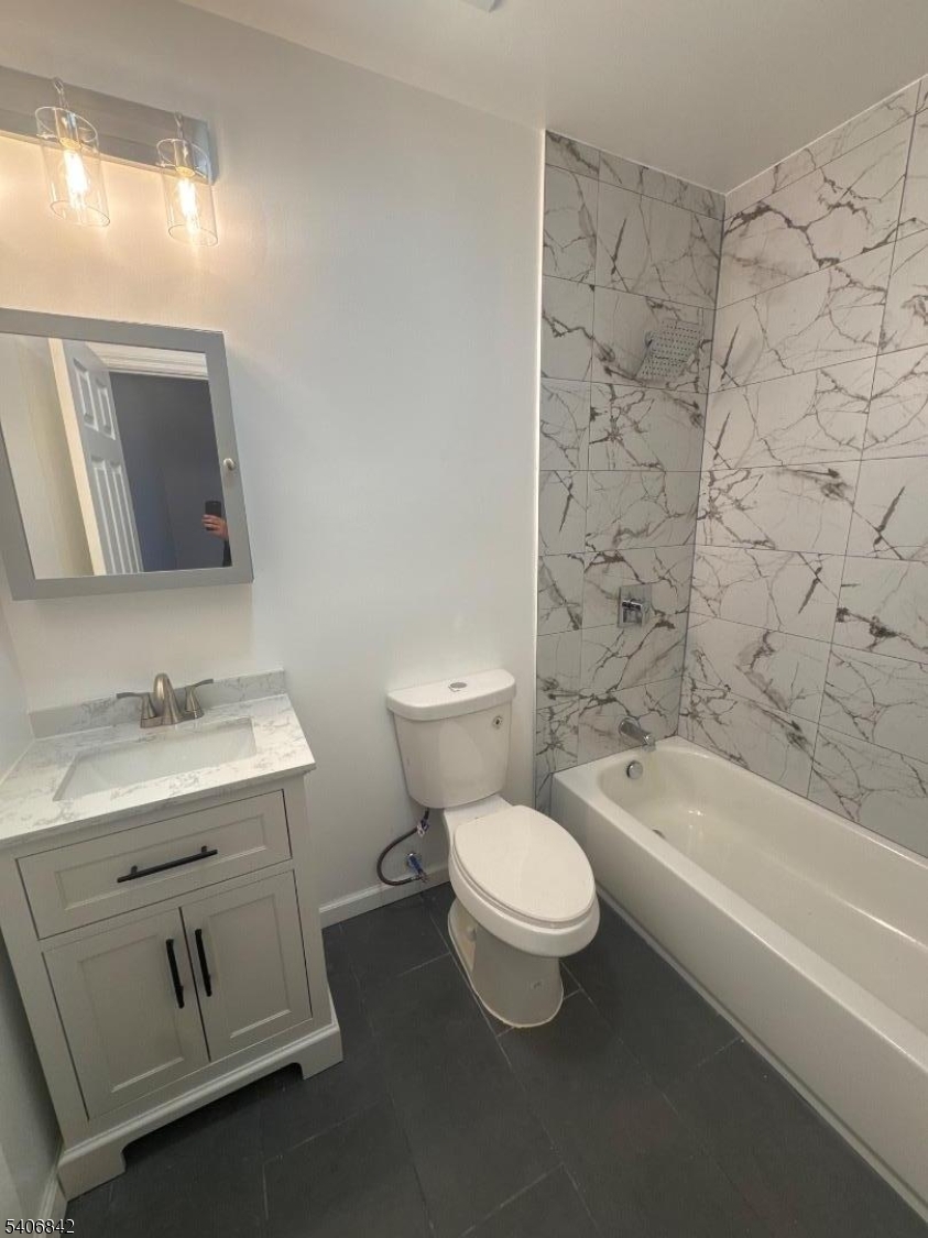 515 West End Avenue Elizabeth, NJ 07202 - Photo 9 of 9 a bathroom with a granite countertop toilet a sink and a bathtub