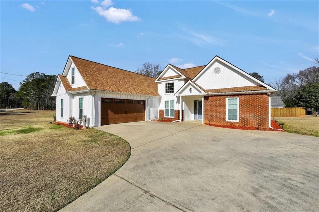 130 Deep Step Road Covington, GA 30014 - Photo 1 of 35 a front view of a house with a yard and garage