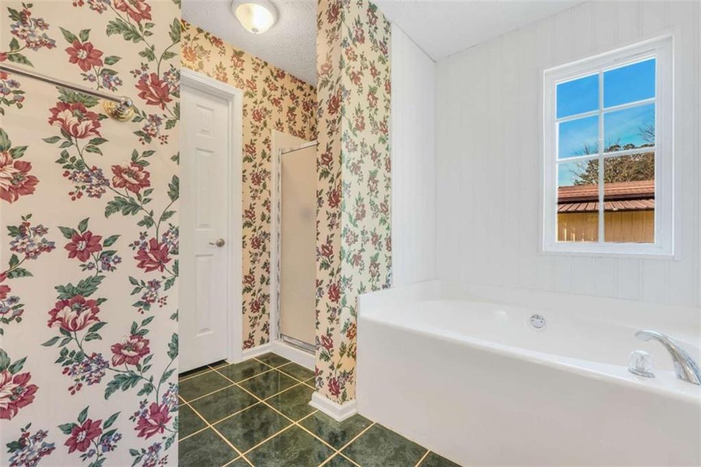 130 Deep Step Road Covington, GA 30014 - Photo 24 of 35 a bathroom with a bathtub and shower