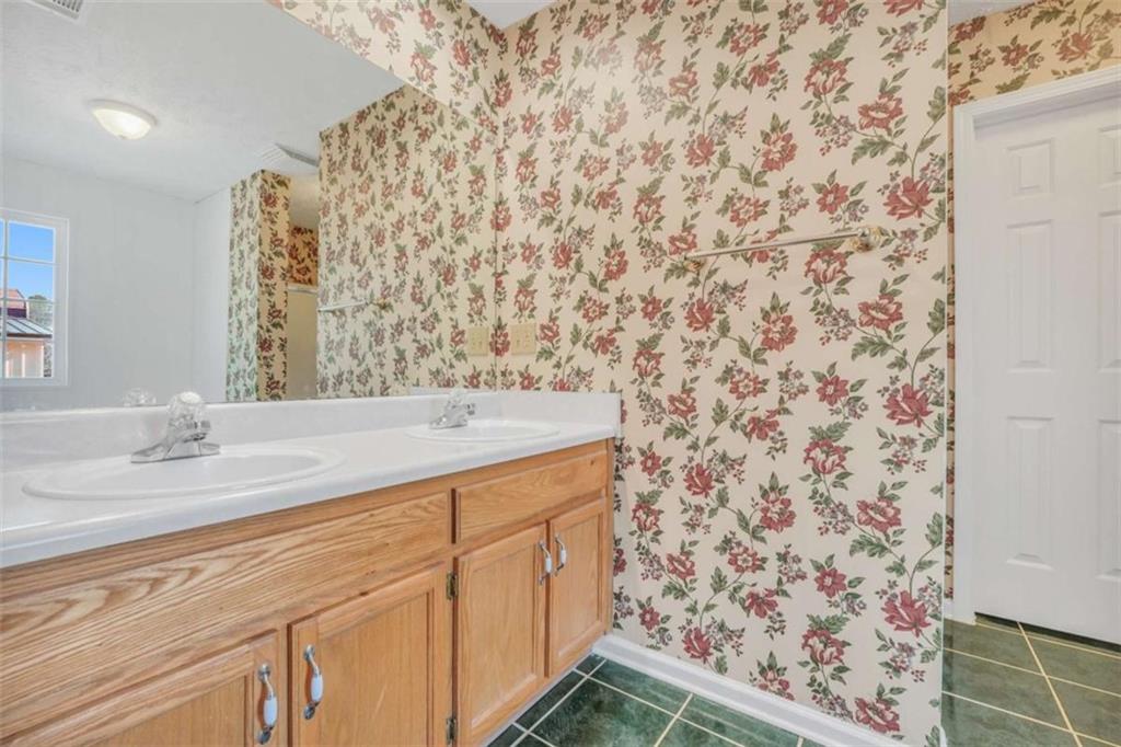 130 Deep Step Road Covington, GA 30014 - Photo 26 of 35 a bathroom with a granite countertop sink and a mirror