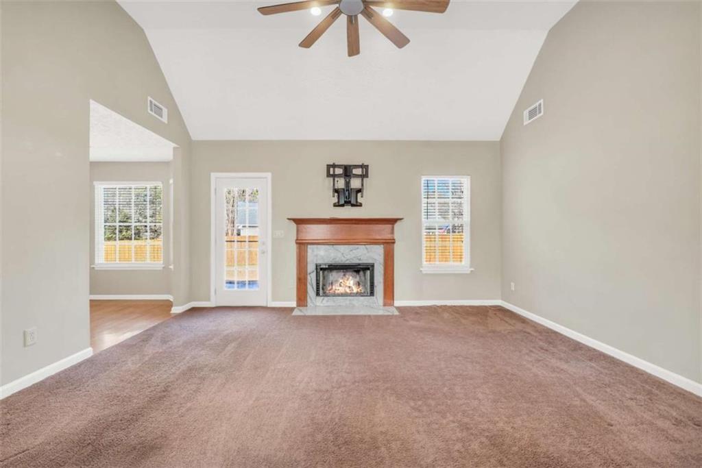 130 Deep Step Road Covington, GA 30014 - Photo 29 of 35 an empty room with windows and fireplace