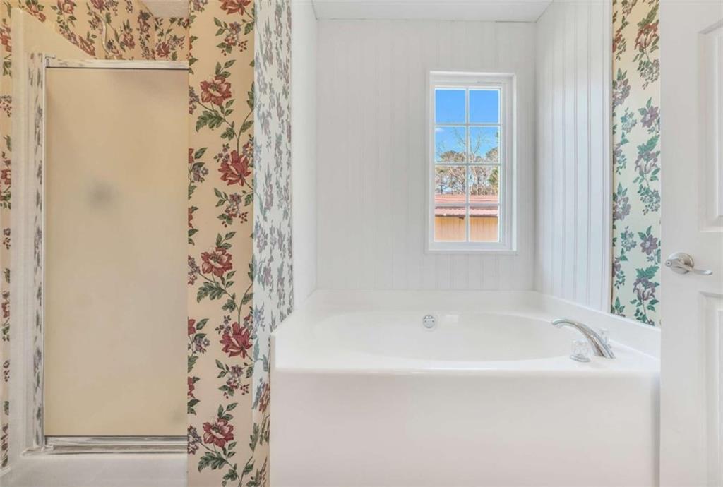 130 Deep Step Road Covington, GA 30014 - Photo 31 of 35 a white bath tub sitting next to a shower