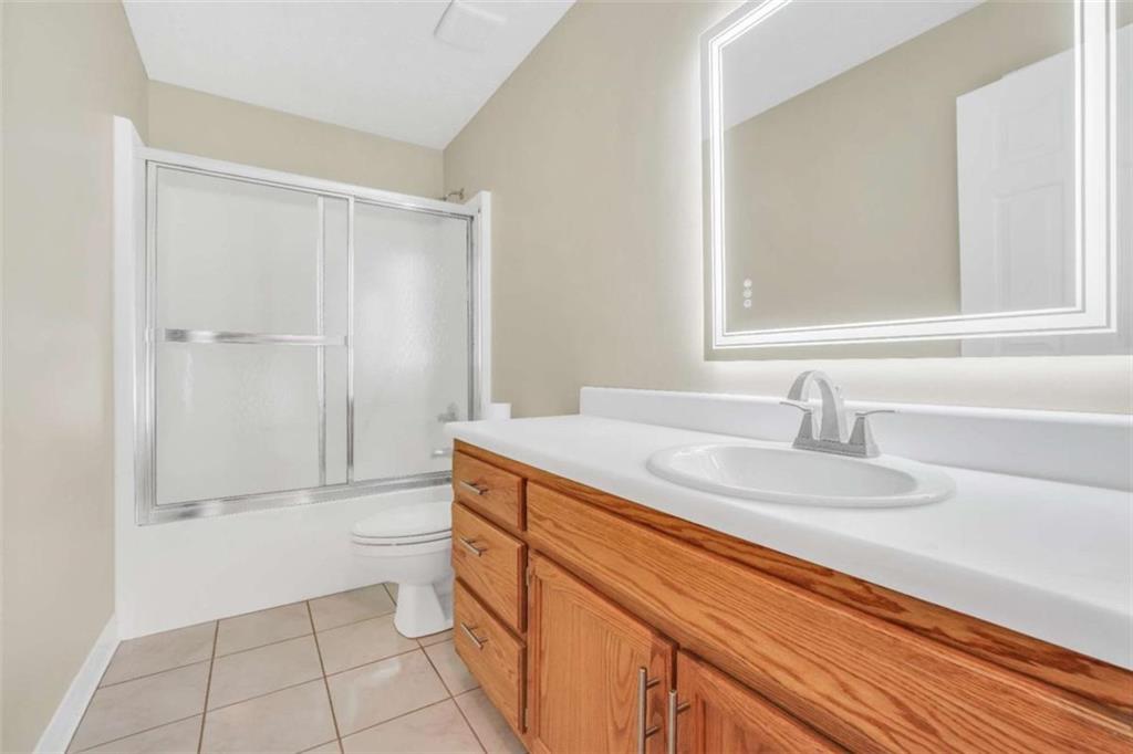 130 Deep Step Road Covington, GA 30014 - Photo 8 of 35 a bathroom with a granite countertop sink a toilet and a mirror