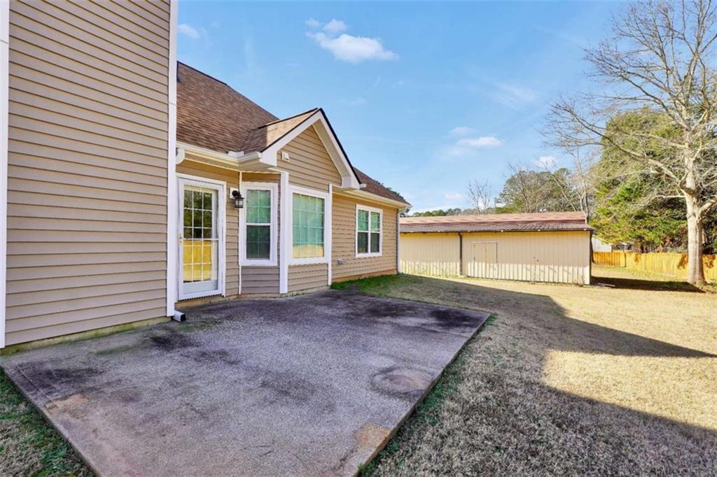 130 Deep Step Road Covington, GA 30014 - Photo 9 of 35 a view of a yard in front of a house with large windows
