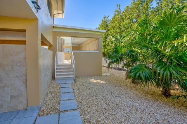 a room with pool table and glass windows