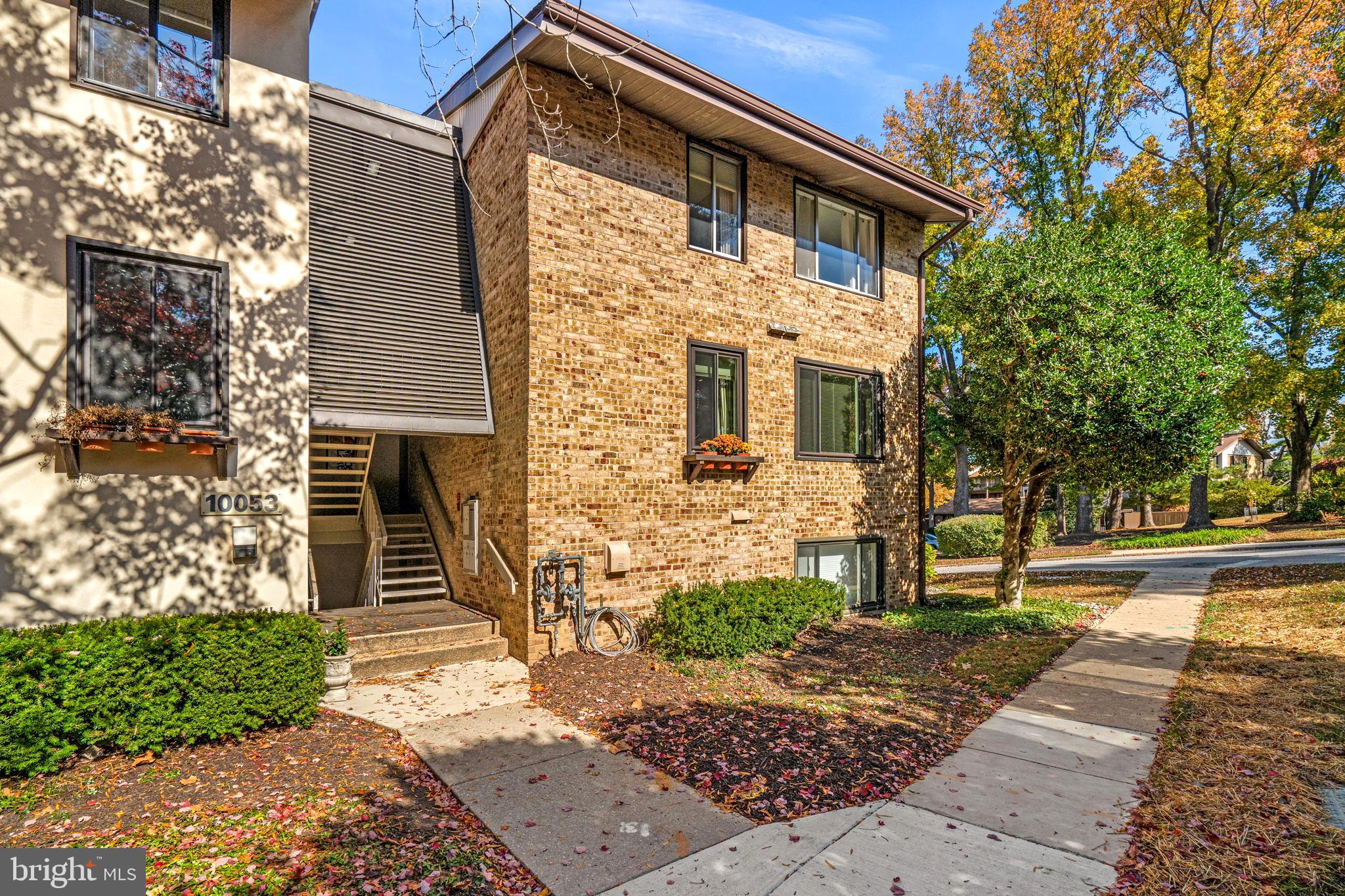 10053 Windstream Drive, Unit 3 Columbia, MD 21044 - Photo 1 of 30 a front view of a house with a garden