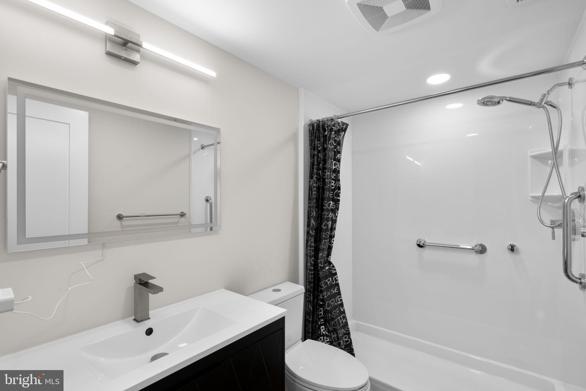 10053 Windstream Drive, Unit 3 Columbia, MD 21044 - Photo 14 of 30 a bathroom with a sink toilet and shower