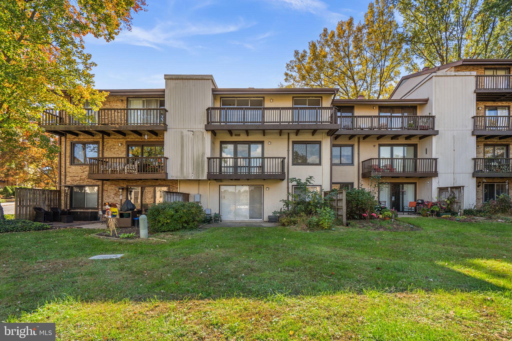 10053 Windstream Drive, Unit 3 Columbia, MD 21044 - Photo 30 of 30 a front view of a building with a yard