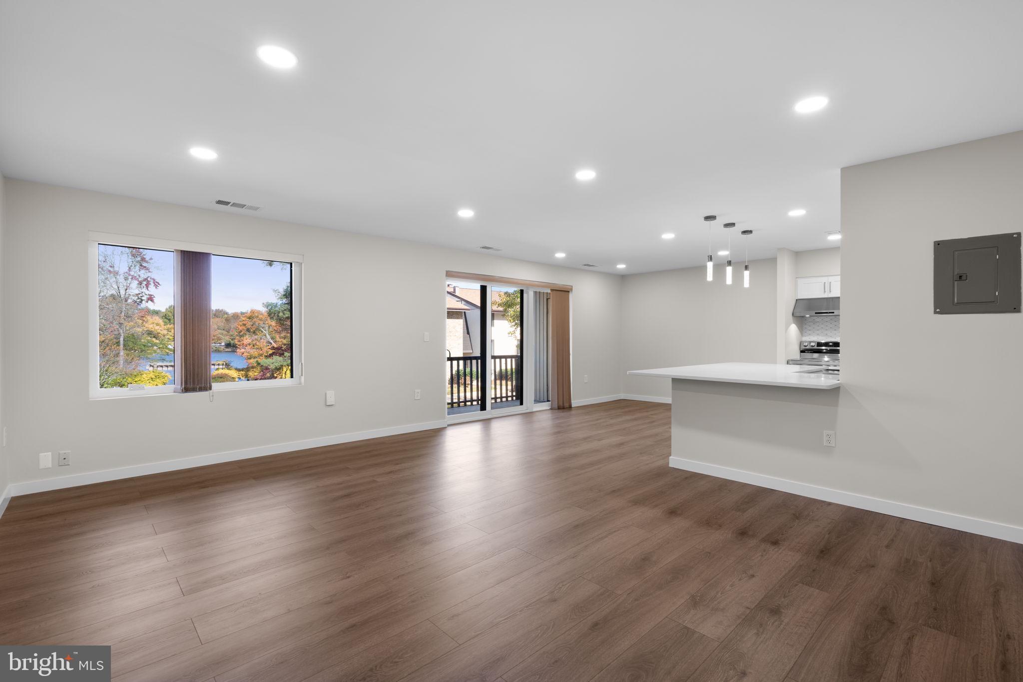10053 Windstream Drive, Unit 3 Columbia, MD 21044 - Photo 3 of 30 an open space with kitchen view and wooden floor