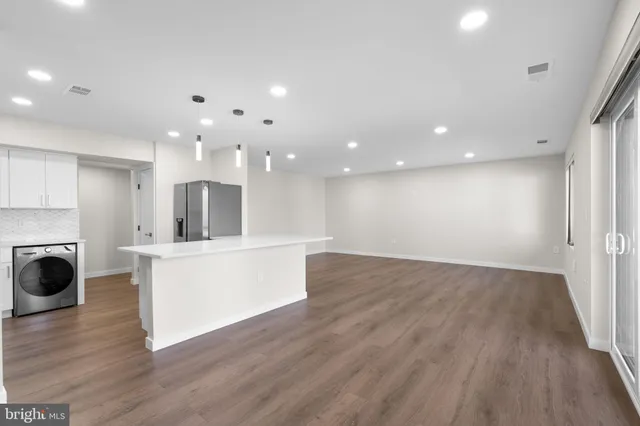 a view of kitchen with sink and wooden floor