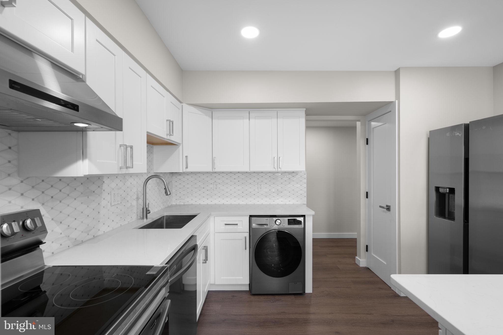 10053 Windstream Drive, Unit 3 Columbia, MD 21044 - Photo 8 of 30 a kitchen with a sink a stove and cabinets