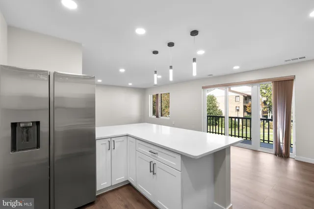 a large kitchen with a large window and stainless steel appliances
