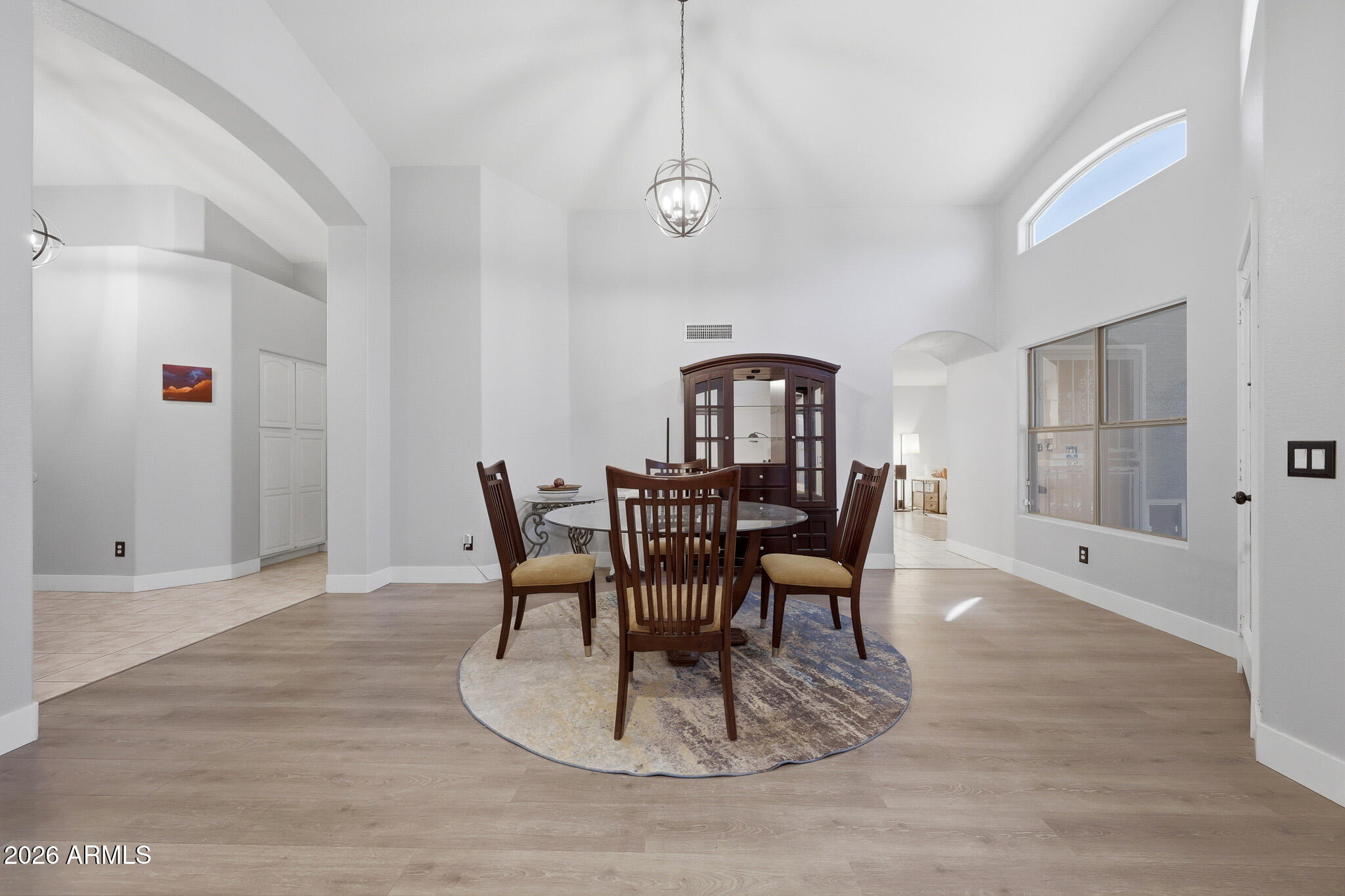 2153 East Kempton Road Chandler, AZ 85225 - Photo 32 of 50 a dining room with furniture a potted plant and wooden floor