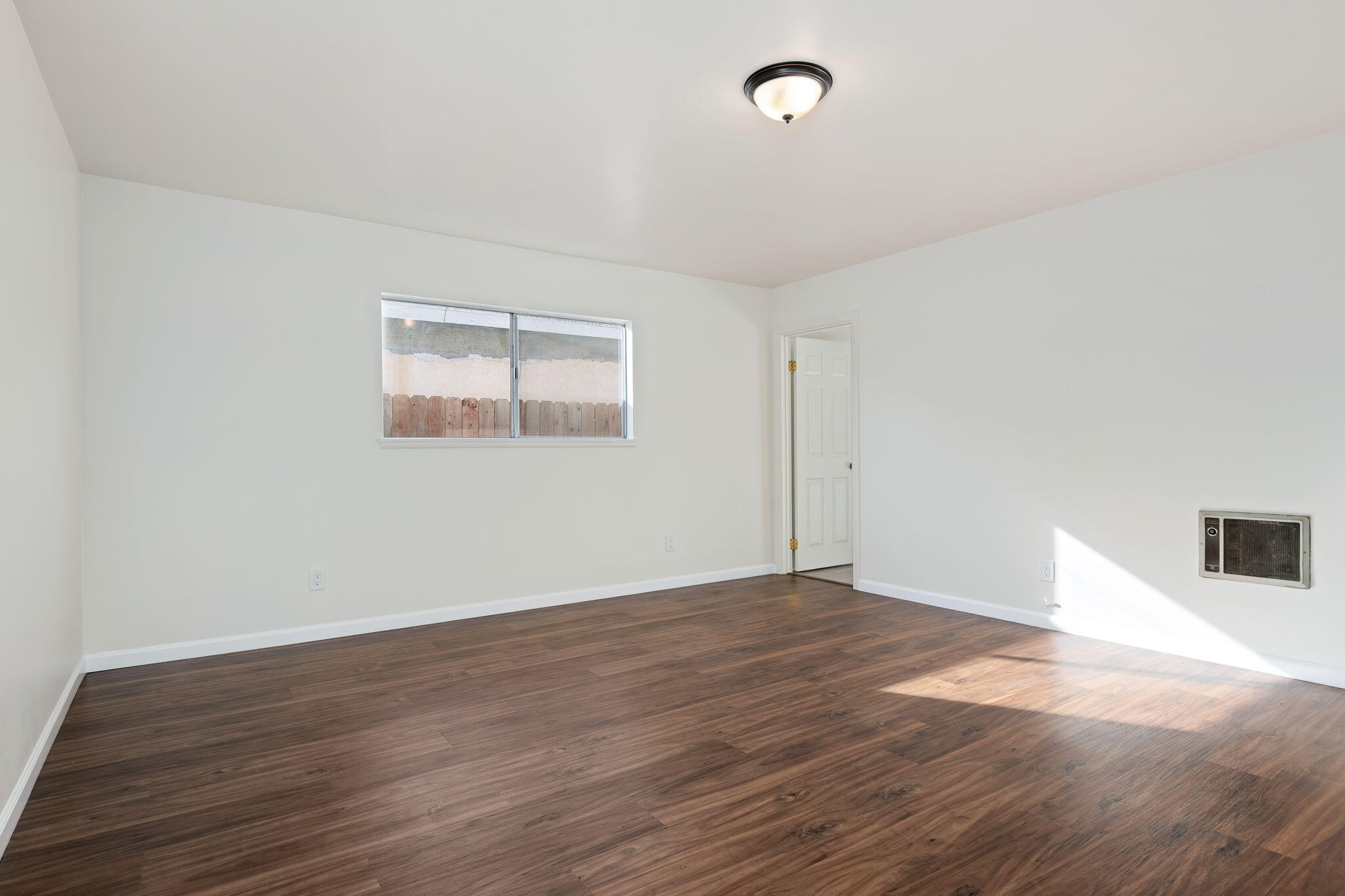 325 North J Street Oxnard, CA 93030 - Photo 13 of 25 an empty room with wooden floor and windows