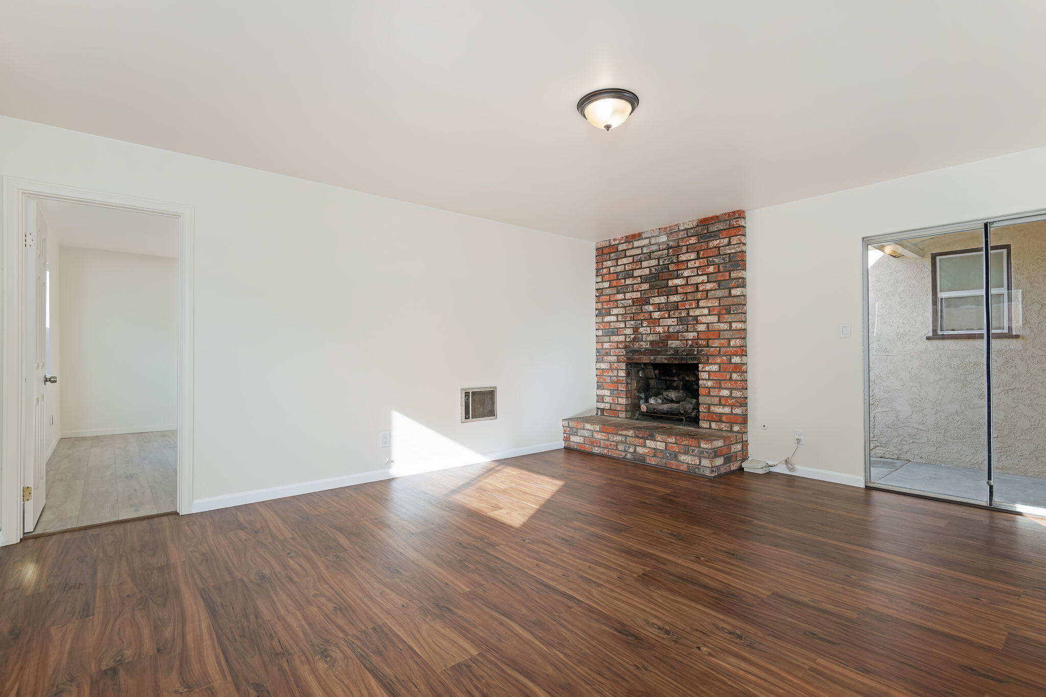 325 North J Street Oxnard, CA 93030 - Photo 14 of 25 an empty room with wooden floor and fireplace