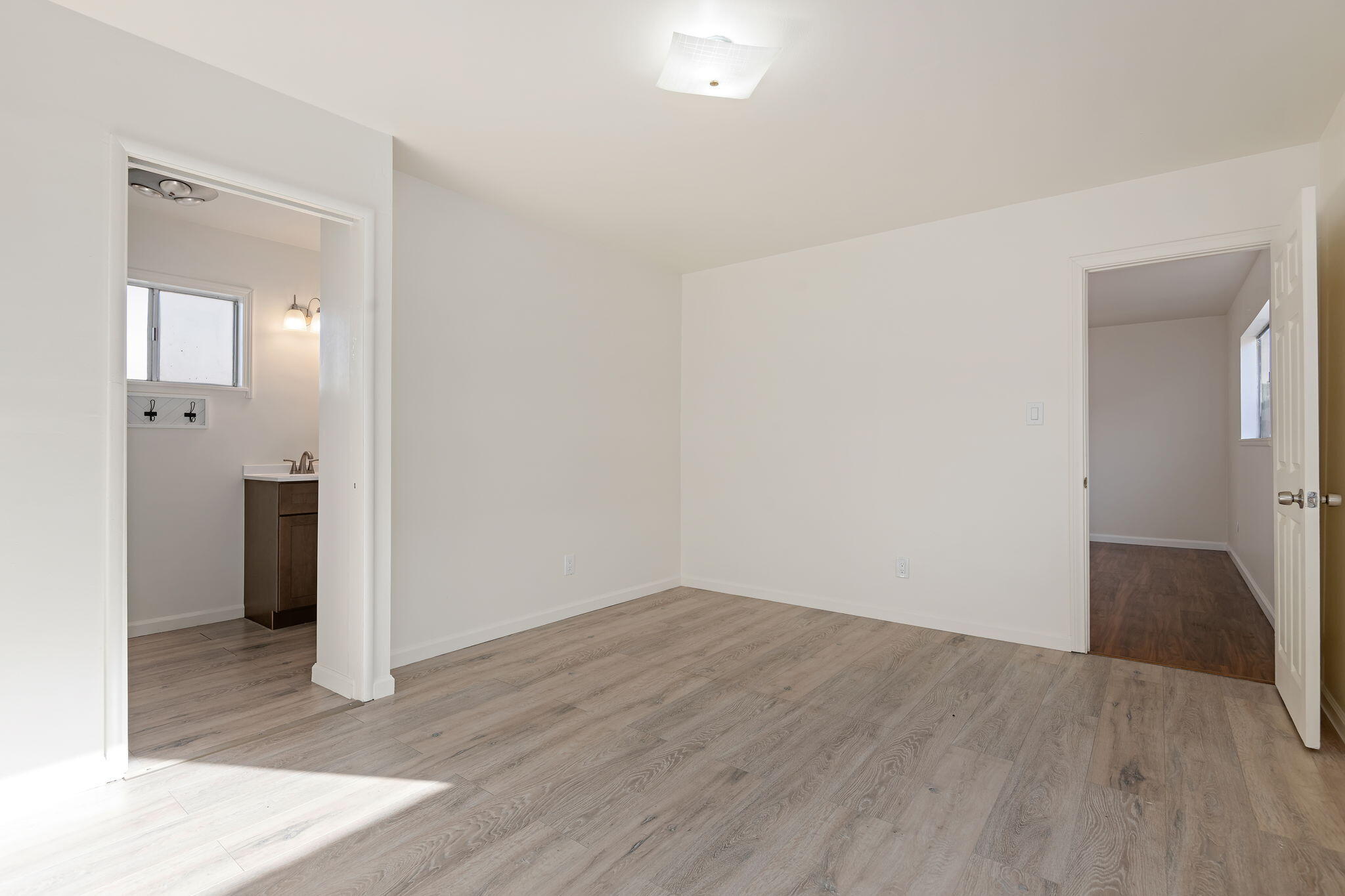 325 North J Street Oxnard, CA 93030 - Photo 17 of 25 an empty room with wooden floor and windows