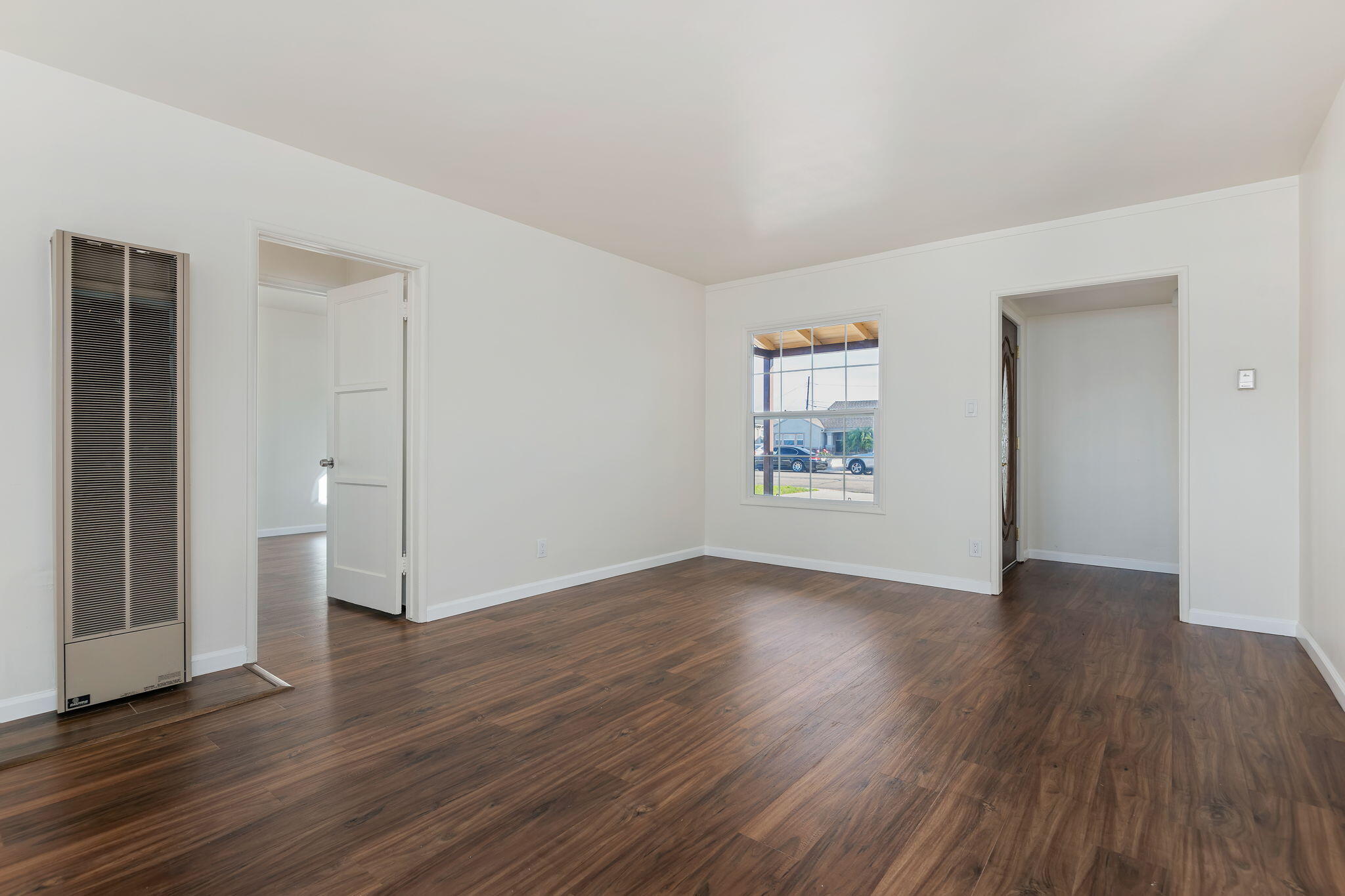 325 North J Street Oxnard, CA 93030 - Photo 6 of 25 an empty room with wooden floor and a window