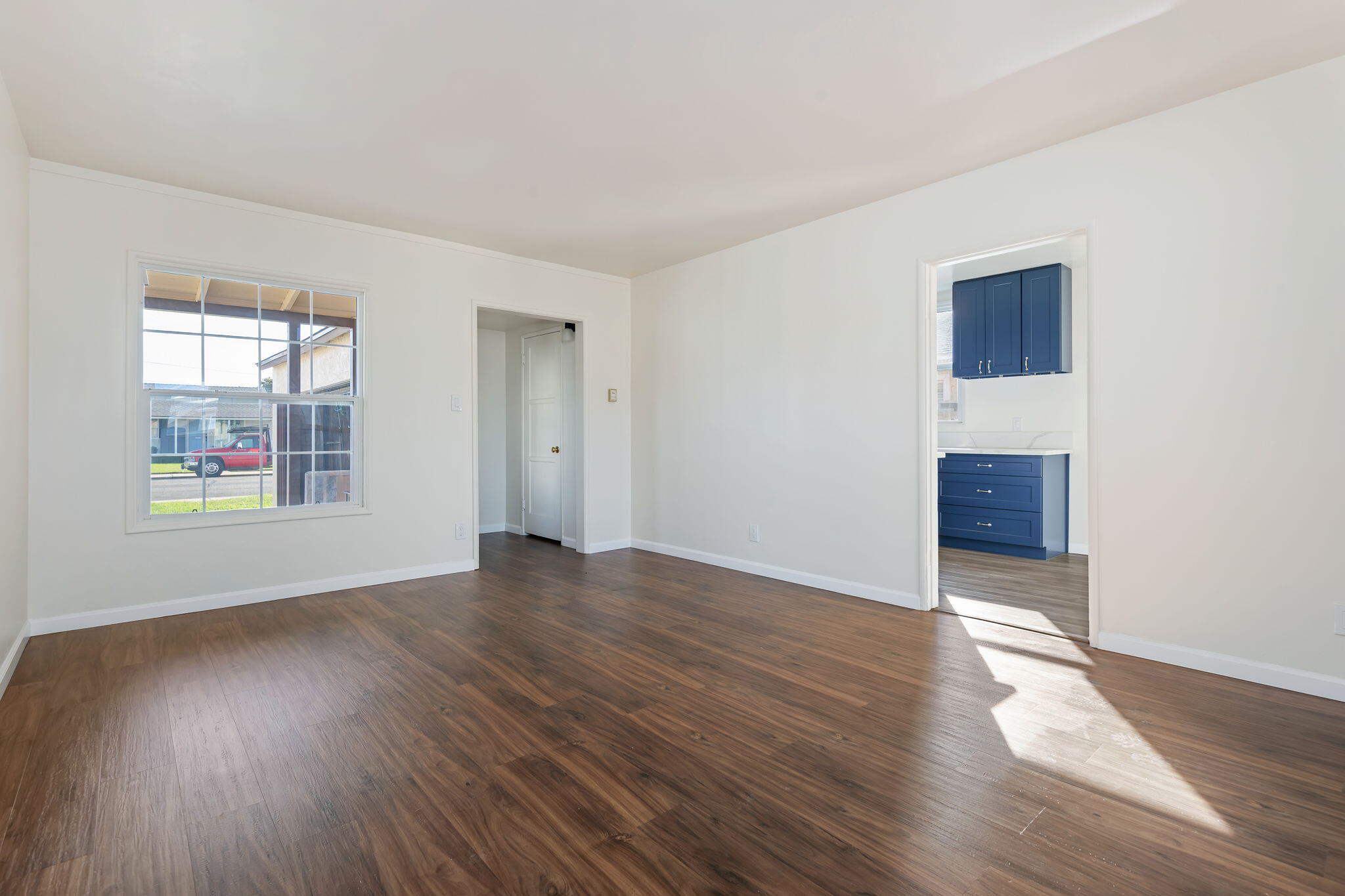 325 North J Street Oxnard, CA 93030 - Photo 7 of 25 an empty room with wooden floor and window