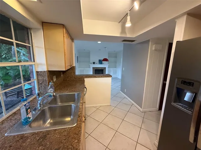 a kitchen with a sink and a refrigerator