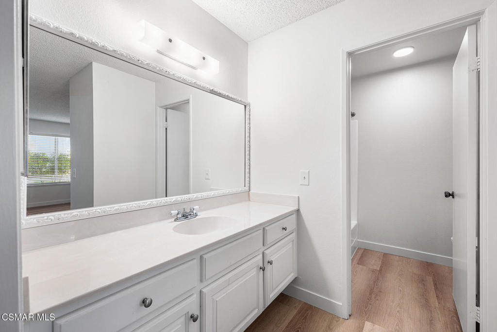 1748 Sinaloa Road, Unit 158 Simi Valley, CA 93065 - Photo 12 of 21 a bathroom with a sink a mirror and a shower