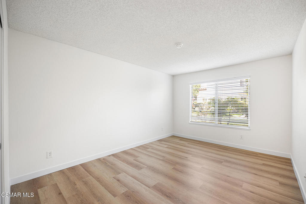 1748 Sinaloa Road, Unit 158 Simi Valley, CA 93065 - Photo 16 of 21 an empty room with wooden floor and windows