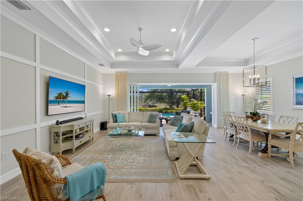 6359 Antigua Way Naples, FL 34113 - Photo 11 of 48 a living room with furniture and a flat screen tv