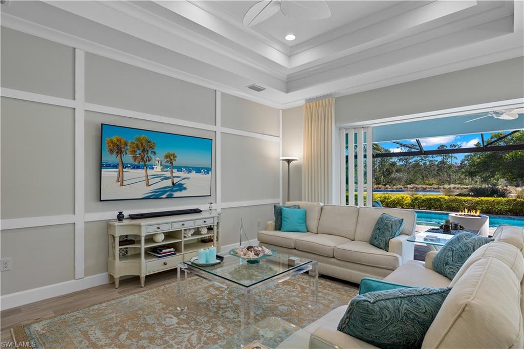 6359 Antigua Way Naples, FL 34113 - Photo 12 of 48 a living room with furniture a rug and a large window