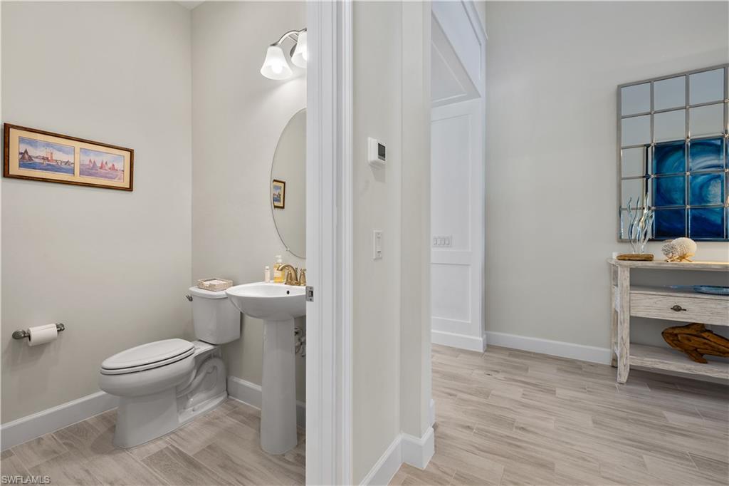 6359 Antigua Way Naples, FL 34113 - Photo 14 of 48 a bathroom with a toilet and a sink