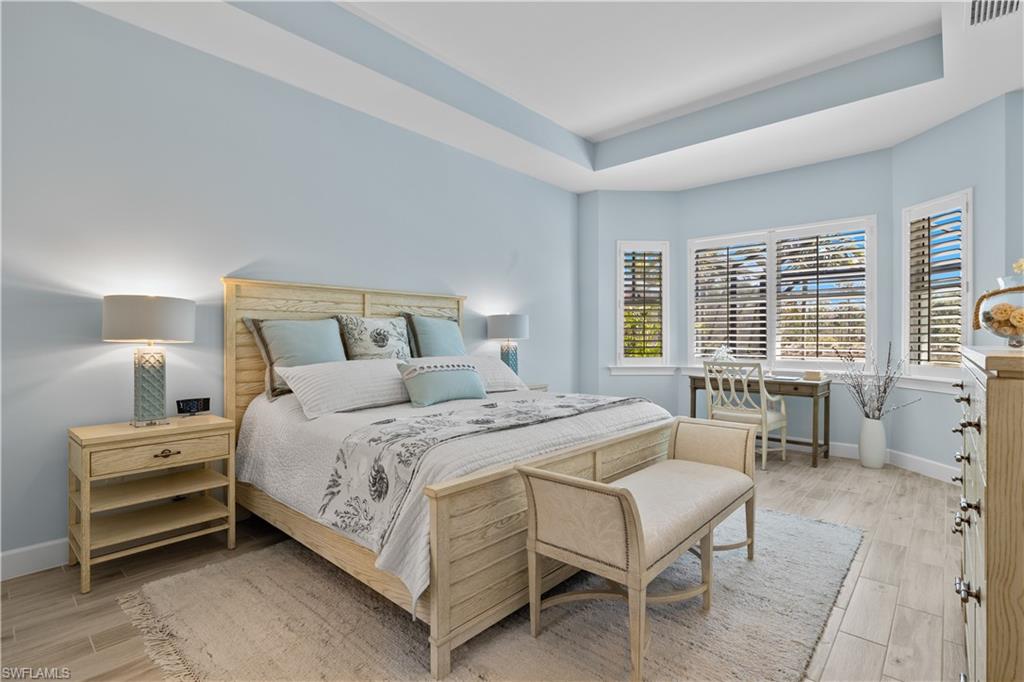 6359 Antigua Way Naples, FL 34113 - Photo 15 of 48 a bedroom with a bed and a table chair