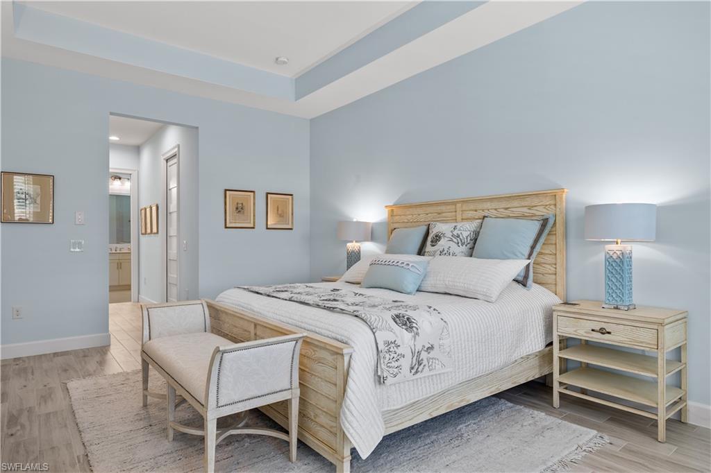 6359 Antigua Way Naples, FL 34113 - Photo 16 of 48 a bedroom with a bed and a dresser
