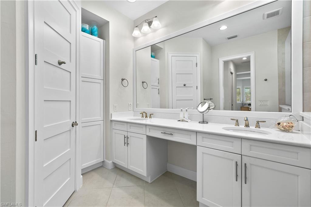 6359 Antigua Way Naples, FL 34113 - Photo 19 of 48 a bathroom with a double vanity sink mirror and double