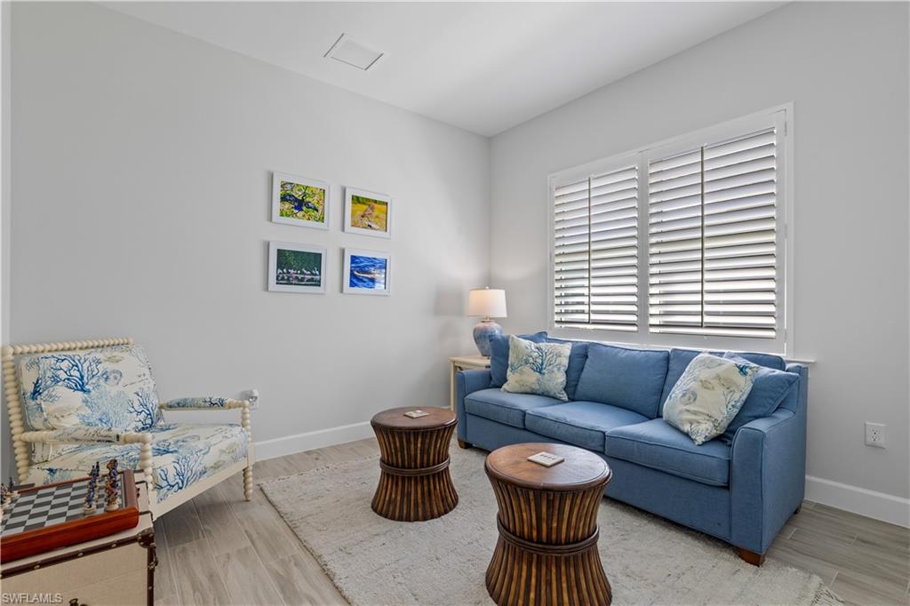 6359 Antigua Way Naples, FL 34113 - Photo 23 of 48 a living room with furniture and a window